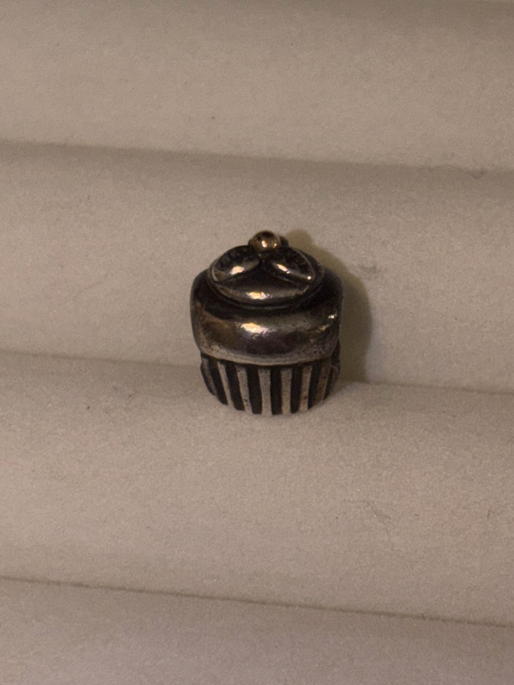 retired Pandora two-tone cupcake charm made of sterling silver and 14k gold.